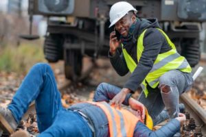 A man attends to an injured co worker at a job site in Texas
