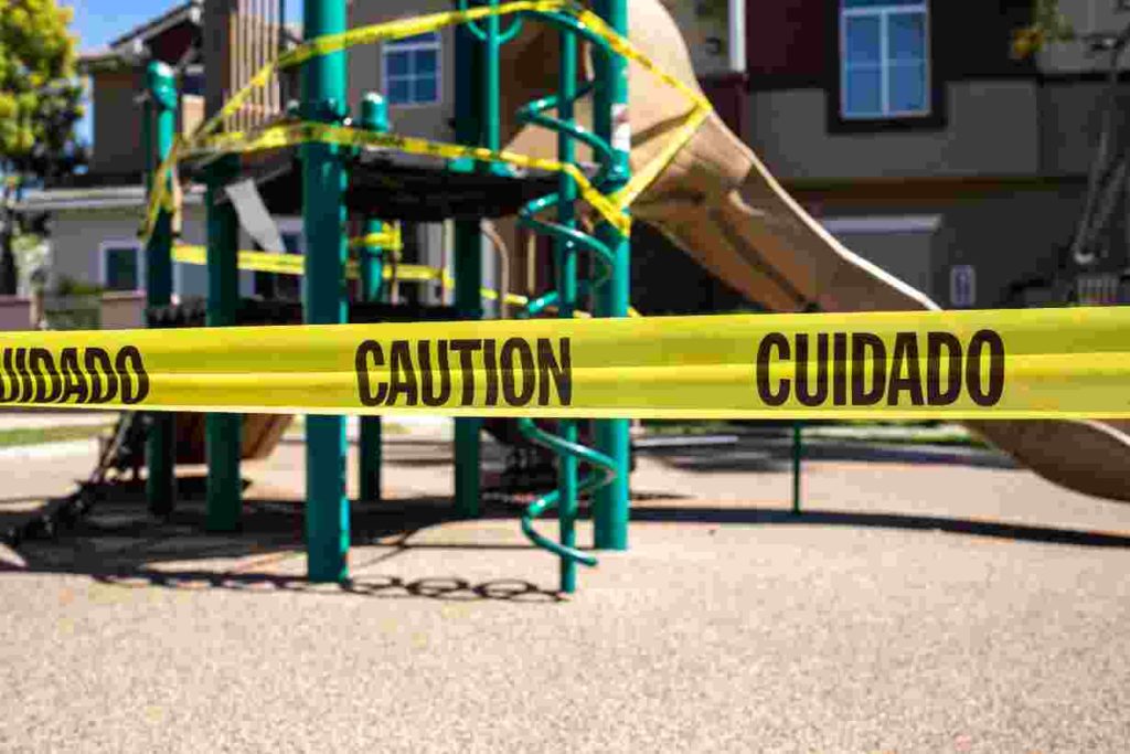 A closed playground with caution take
