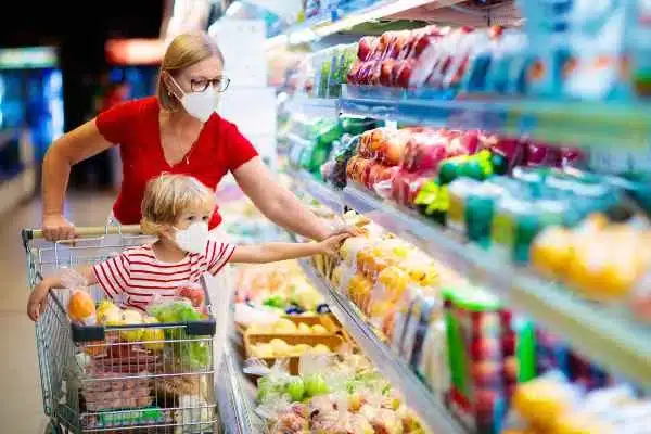 A mother and son are grocery shopping in a Houston store