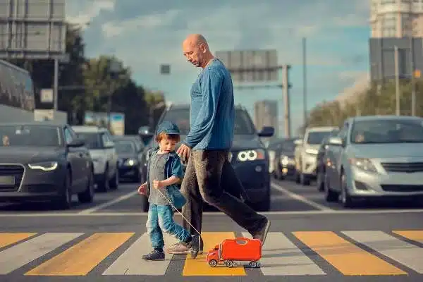 Father and son use crosswalk to get to their destination in Houston 