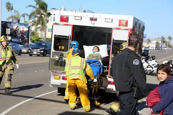 An EMT vehicle and crew attending an accident scene.